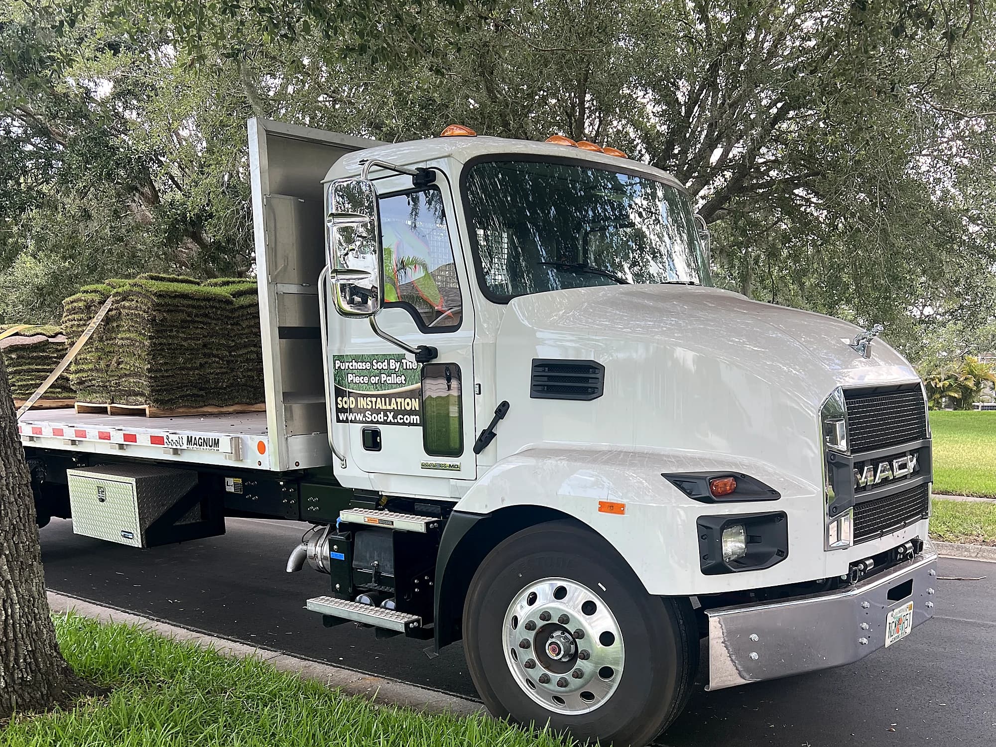 A Sod-X flatbed delivering pallets of sod to a Tampa Bay home